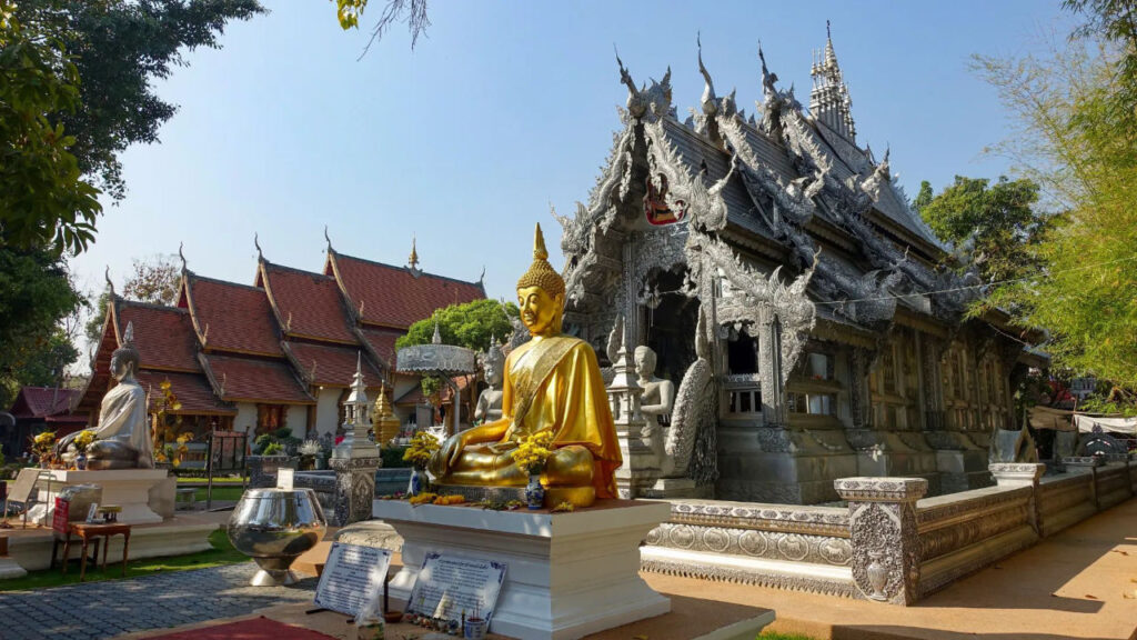 A Buddha statue in front of a temple, symbolizing peace and tranquility