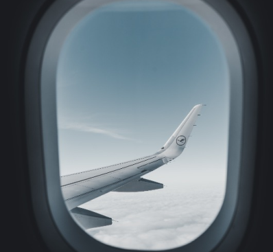 View of airplane wings and clouds from window